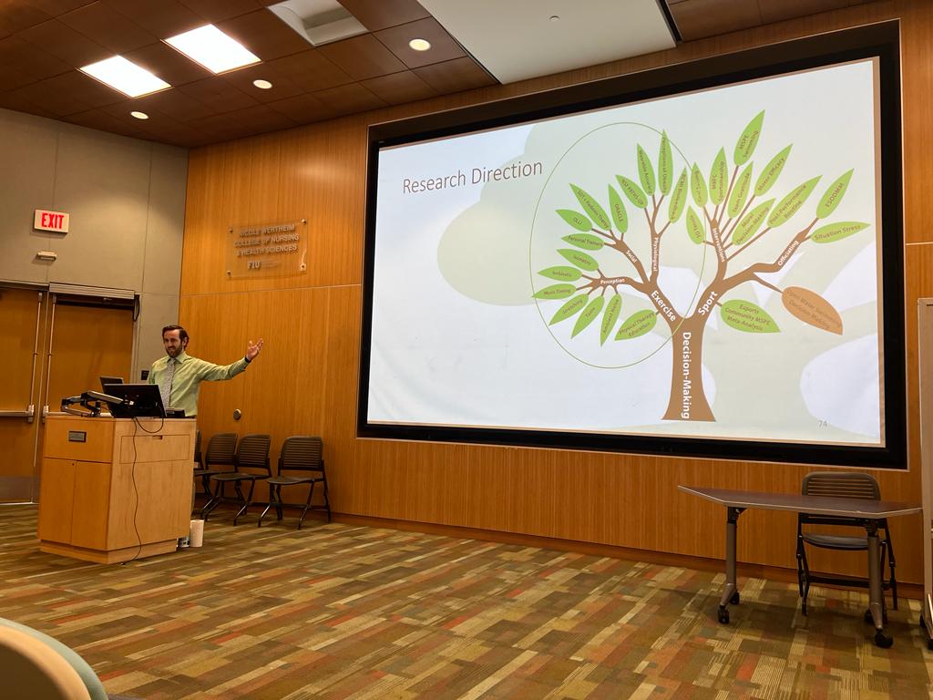 Dr. Jason Kostrna speaking at a conference about obesity